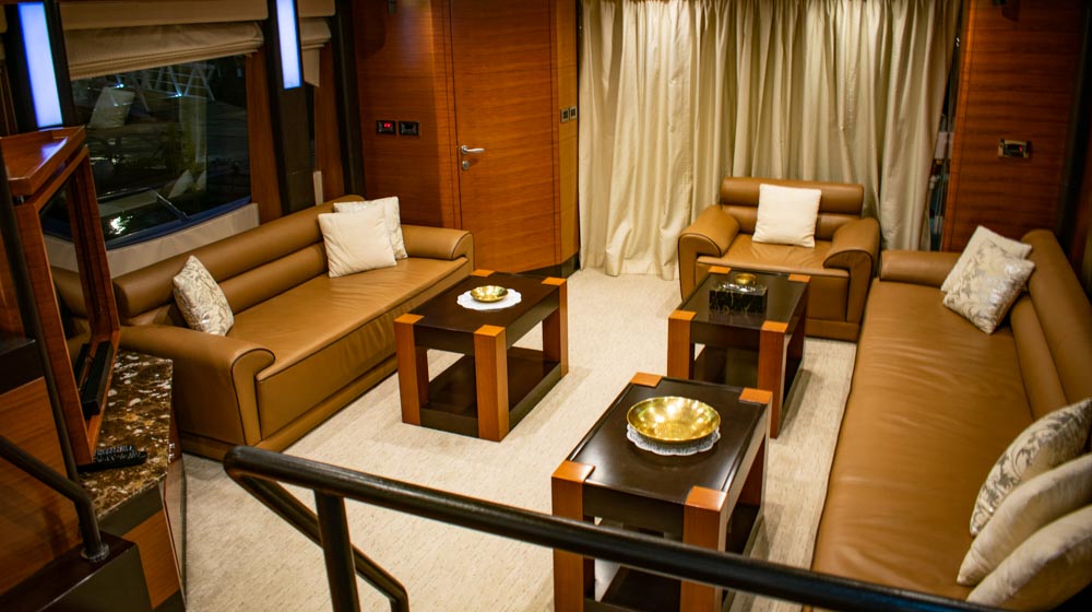 yacht saloon featuring leather sofas, tv, speakers, large windows and contemporary interiors